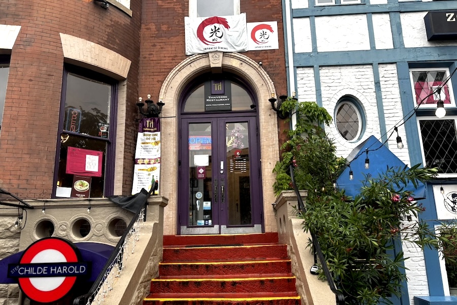 A red stairway leads to the brightly painted entrance of KO Japanese Dining, housed in a historic brick building in Dupont Circle.