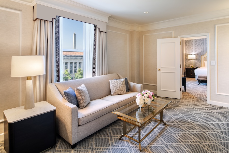 An elegant hotel room with a view of the Washington Monument. 