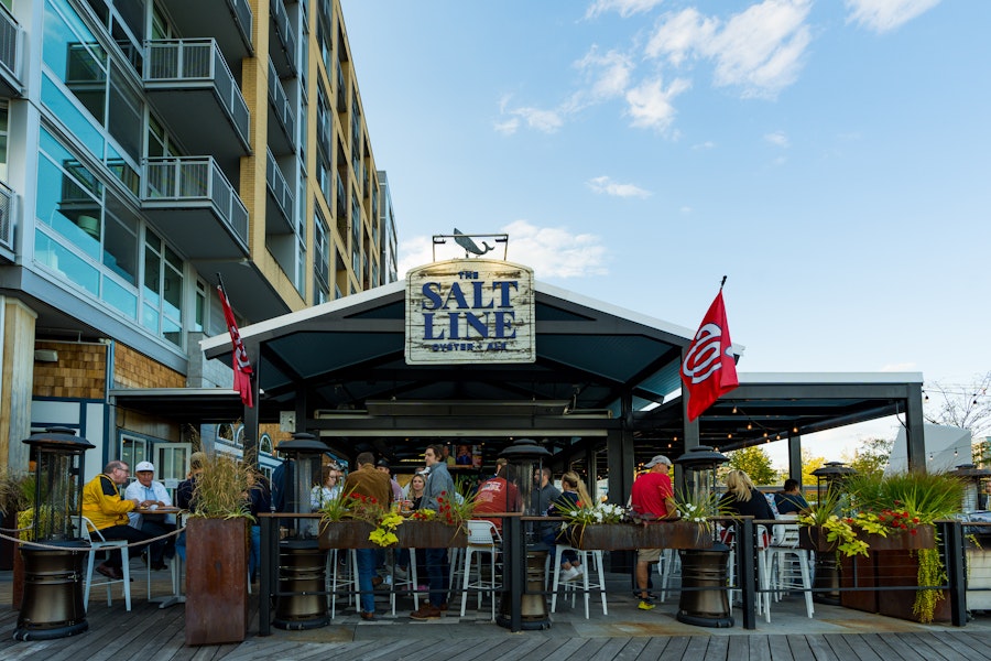 The outdoor patio of the Salt Line on a sunny day, decorate with nautical decor.