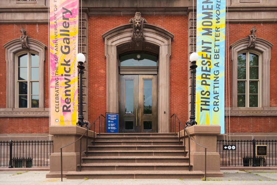 The front entrance of the Renwick Gallery with banners reading “This Present Moment” and “Crafting a Better World.”