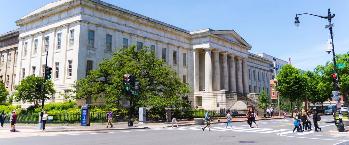 Pedestrians cross the street outside the National Portrait Gallery in Washington, DC.
