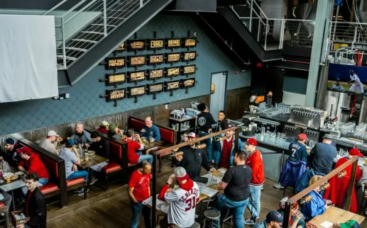 Interior of a brewery populated with Nationals merch and people in jerseys. 