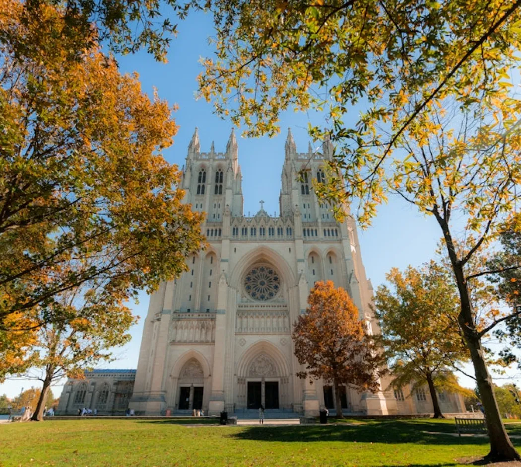 Washington National Cathedral framed by trees with fall colors.